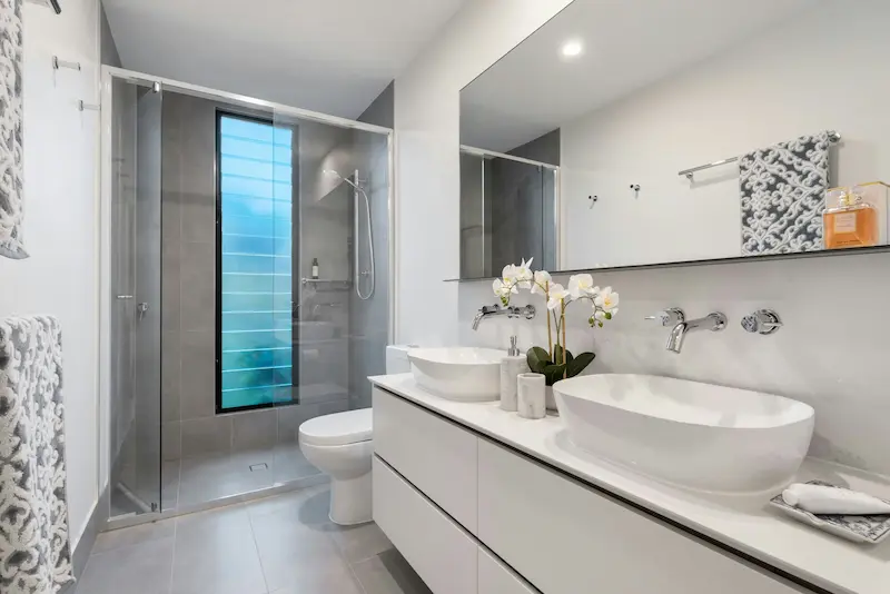 Double sink bathroom vanity with matte black faucets and backlit mirror installed during a Sunnyvale bathroom upgrade by Prime Remodel